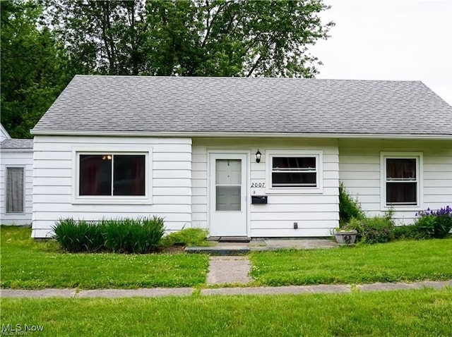 2007 W 59th St, Ashtabula, OH 44004 - view of front of home with roof with shingles and a front lawn
