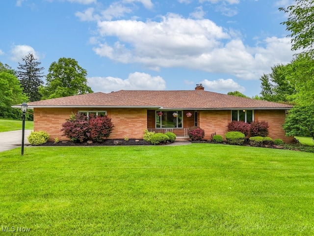 8009 Brookside Rd, Independence, OH 44131 - ranch-style home with a chimney, a front yard, a porch, and brick siding