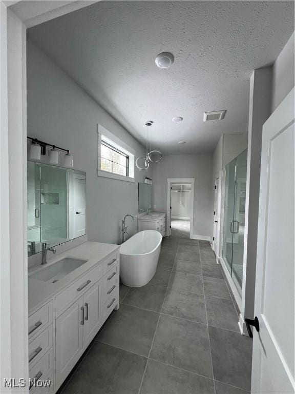 275 Glengarry Dr, Aurora, OH 44202 - full bath with vanity, a freestanding tub, a stall shower, a textured ceiling, and tile patterned flooring