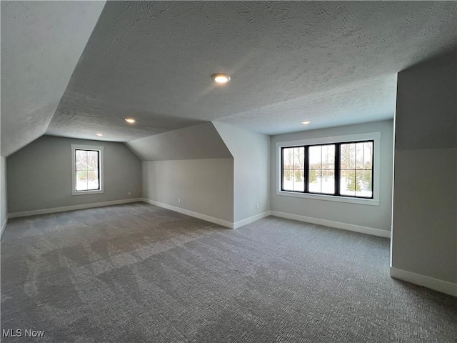 275 Glengarry Dr, Aurora, OH 44202 - bonus room with baseboards, lofted ceiling, a textured ceiling, carpet flooring, and recessed lighting