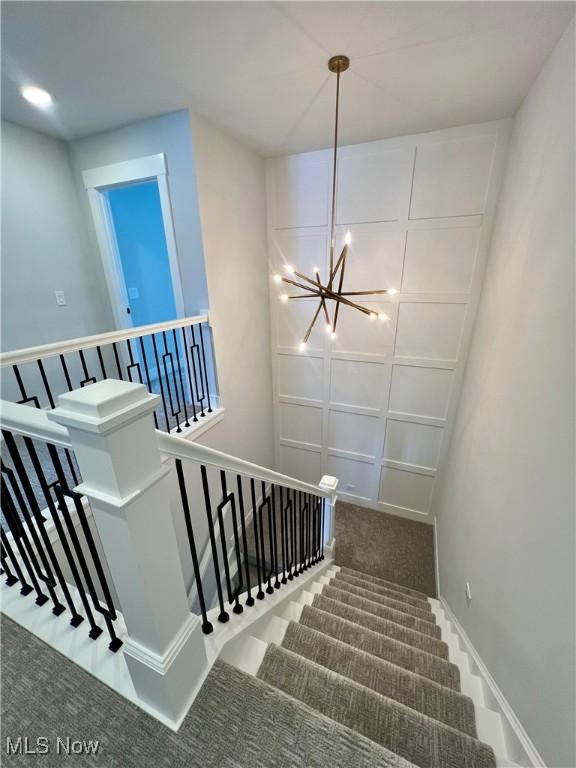 275 Glengarry Dr, Aurora, OH 44202 - staircase featuring carpet flooring and a chandelier