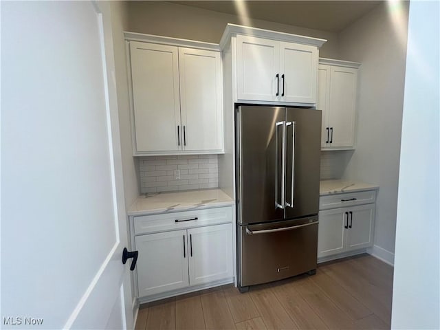 275 Glengarry Dr, Aurora, OH 44202 - kitchen featuring high quality fridge, white cabinets, light wood finished floors, and tasteful backsplash