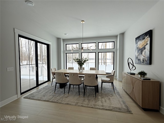 275 Glengarry Dr, Aurora, OH 44202 - dining room with baseboards, a chandelier, and light wood-type flooring