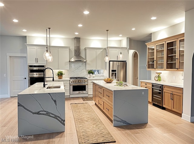 275 Glengarry Dr, Aurora, OH 44202 - kitchen with stainless steel appliances, wall chimney exhaust hood, beverage cooler, an island with sink, and recessed lighting