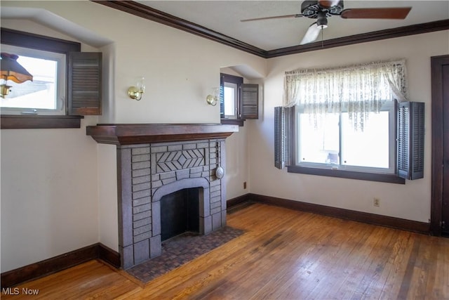 4515 Tuxedo Ave, Parma, OH 44134 - unfurnished living room with a ceiling fan, crown molding, hardwood / wood-style floors, baseboards, and a brick fireplace