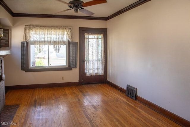 4515 Tuxedo Ave, Parma, OH 44134 - spare room with crown molding, a ceiling fan, baseboards, hardwood / wood-style flooring, and a fireplace