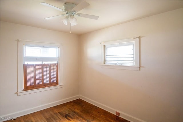 4515 Tuxedo Ave, Parma, OH 44134 - spare room with baseboards, dark wood-style flooring, and a ceiling fan