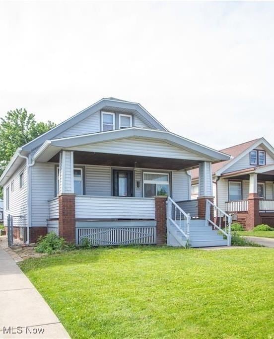 4515 Tuxedo Ave, Parma, OH 44134 - bungalow-style house featuring a porch and a front yard