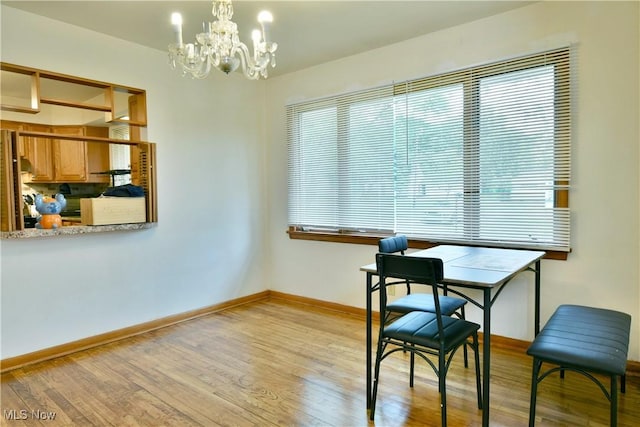 138 Mill Creek Rd, Niles, OH 44446 - dining area with a chandelier, light wood-type flooring, and baseboards