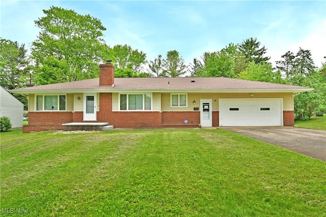 138 Mill Creek Rd, Niles, OH 44446 - ranch-style home with brick siding, driveway, a chimney, an attached garage, and a front yard
