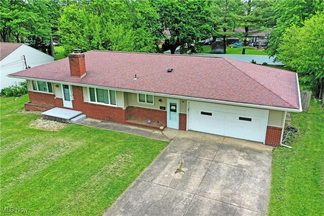 138 Mill Creek Rd, Niles, OH 44446 - single story home featuring brick siding, a chimney, driveway, and a front lawn