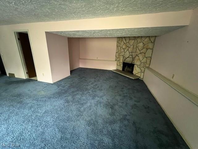 201 Morgan Dr, Painesville, OH 44077 - finished below grade area featuring a textured ceiling, dark carpet, and a fireplace