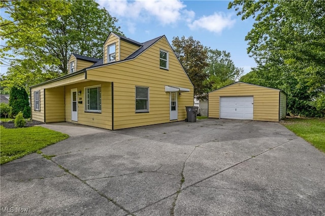 3304 Tangent St, Youngstown, OH 44502 - view of front facade with an outdoor structure, a detached garage, and driveway
