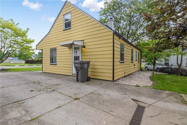 3304 Tangent St, Youngstown, OH 44502 - view of property exterior with a patio area and a chimney