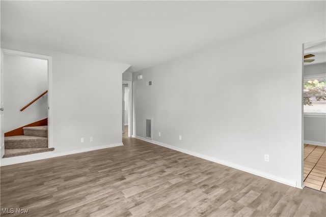 3304 Tangent St, Youngstown, OH 44502 - empty room with wood finished floors, stairs, and baseboards