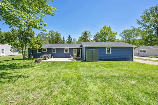 13014 Cherry Ln, Chesterland, OH 44026 - rear view of property featuring an outdoor fire pit, a patio, a lawn, and an outdoor structure