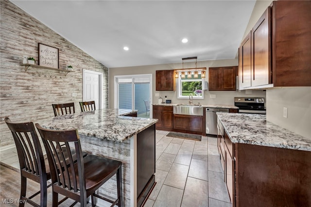 13014 Cherry Ln, Chesterland, OH 44026 - kitchen with a sink, stainless steel appliances, a breakfast bar, vaulted ceiling, and light stone countertops