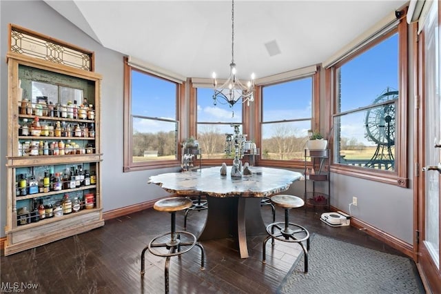 10366 Immel St NE, Canton, OH 44721 - dining space with baseboards, a chandelier, and dark wood finished floors