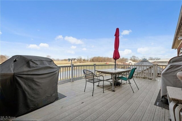 10366 Immel St NE, Canton, OH 44721 - wooden terrace with grilling area, a water view, and outdoor dining area