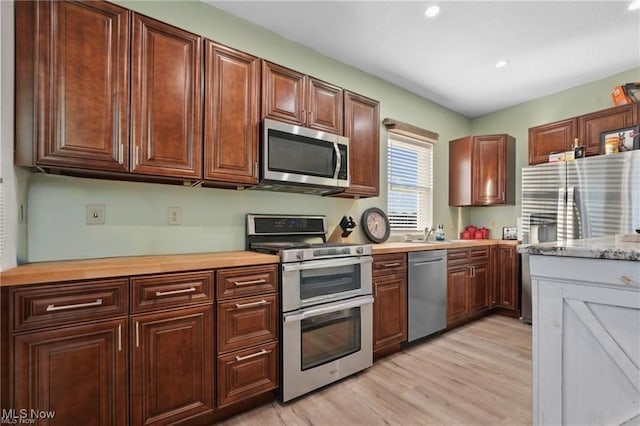 10366 Immel St NE, Canton, OH 44721 - kitchen with stainless steel appliances, light countertops, light wood-type flooring, and recessed lighting