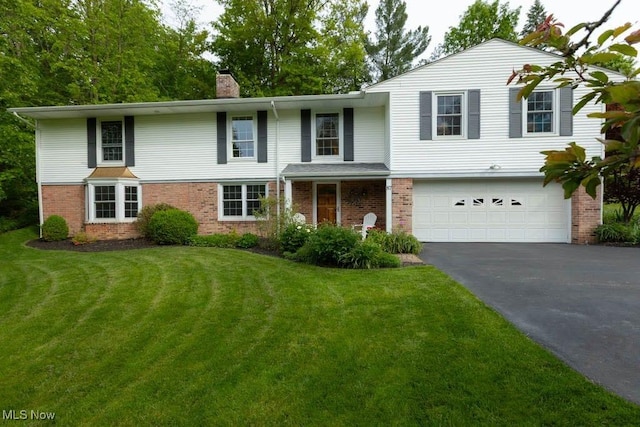 87 Locust Ln, Chagrin Falls, OH 44022 - traditional home featuring asphalt driveway, a garage, a chimney, and brick siding