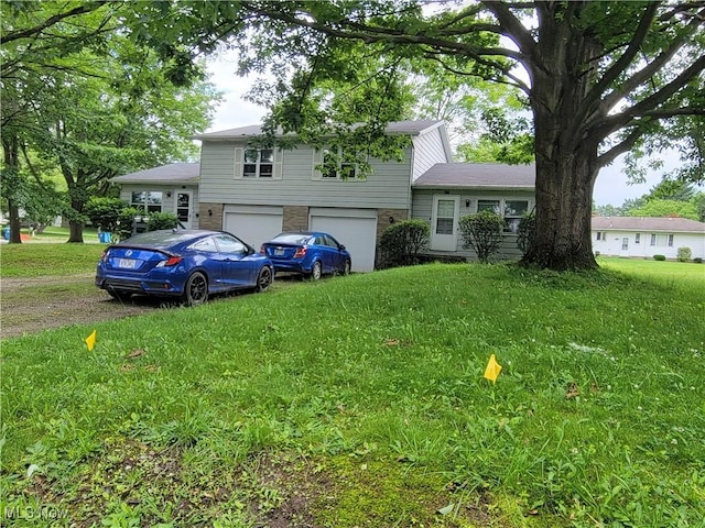 827 Randall Dr, Kent, OH 44240 - view of front of home featuring brick siding, an attached garage, a front yard, and driveway