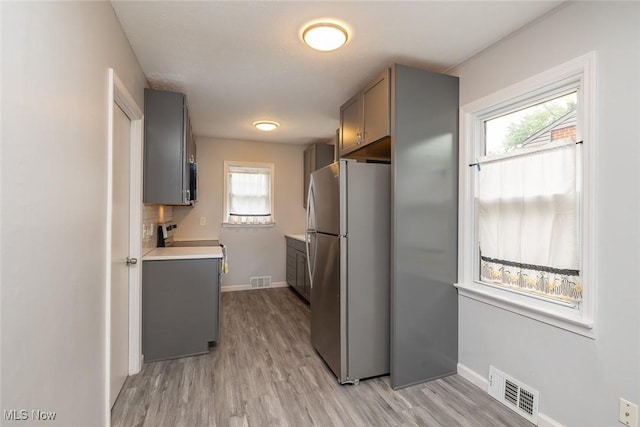 5963 Porter Rd, North Olmsted, OH 44070 - kitchen featuring freestanding refrigerator, gray cabinets, and stove