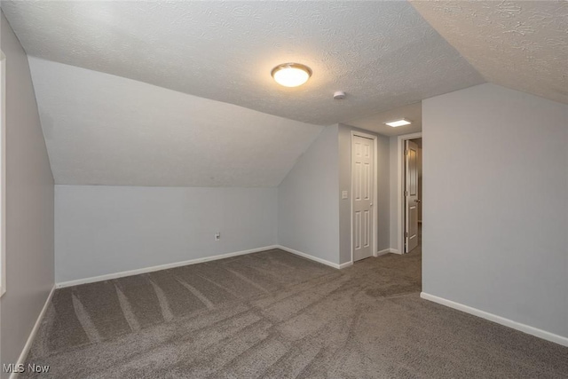 5963 Porter Rd, North Olmsted, OH 44070 - additional living space with carpet floors, lofted ceiling, a textured ceiling, and baseboards