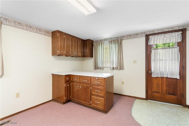 4512 Conestoga Trl, Copley, OH 44321 - kitchen with light countertops, baseboards, brown cabinets, and light carpet