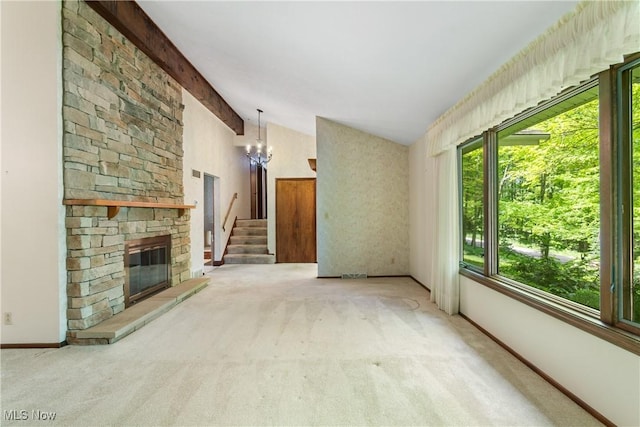 4512 Conestoga Trl, Copley, OH 44321 - unfurnished living room featuring carpet flooring, a chandelier, baseboards, stairs, and a stone fireplace