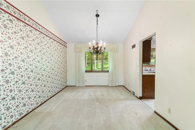 4512 Conestoga Trl, Copley, OH 44321 - unfurnished dining area with a chandelier, lofted ceiling, carpet flooring, and baseboards