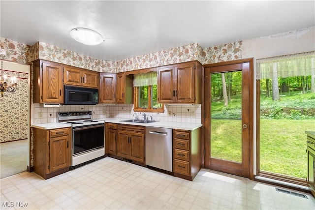 4512 Conestoga Trl, Copley, OH 44321 - kitchen featuring dishwasher, electric stove, black microwave, a sink, and light countertops