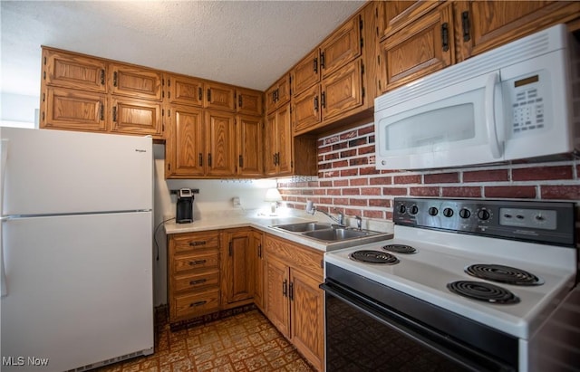142 Marion Ave, Mogadore, OH 44260 - kitchen featuring white appliances, a sink, light countertops, tile patterned floors, and brown cabinetry