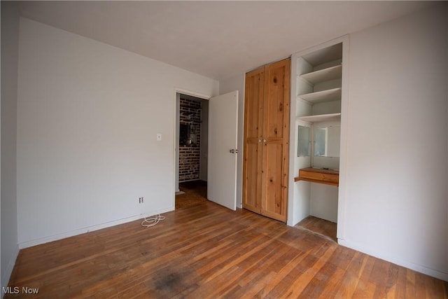 142 Marion Ave, Mogadore, OH 44260 - unfurnished bedroom featuring wood finished floors and baseboards