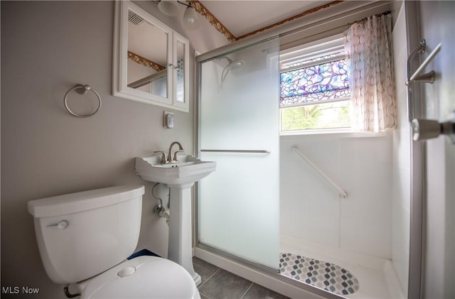 142 Marion Ave, Mogadore, OH 44260 - full bathroom with toilet, a stall shower, and tile patterned flooring