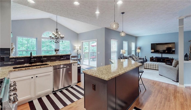 218 Treetop Spur, Copley, OH 44321 - kitchen featuring stainless steel appliances, a sink, light wood-style floors, white cabinetry, and light stone counters