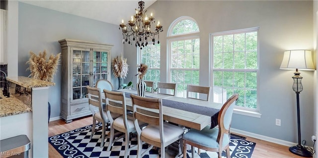 218 Treetop Spur, Copley, OH 44321 - dining area with a chandelier, light wood-style floors, and baseboards