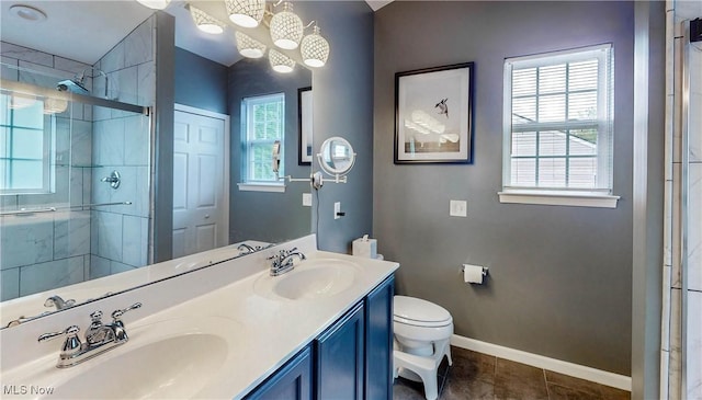 218 Treetop Spur, Copley, OH 44321 - full bathroom featuring a shower stall, toilet, double vanity, baseboards, and tile patterned flooring