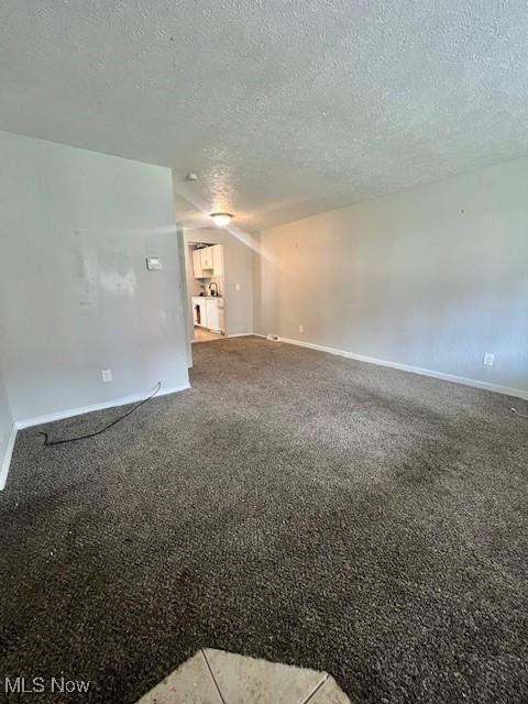 23855 Banbury Cir, Warrensville Heights, OH 44128 - carpeted spare room with a textured ceiling and baseboards