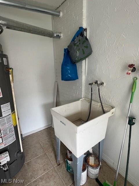 23855 Banbury Cir, Warrensville Heights, OH 44128 - utility room featuring gas water heater and a sink