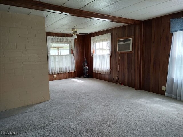 50364 Carroll Rd, East Liverpool, OH 43920 - unfurnished room featuring beam ceiling, carpet floors, a wall unit AC, wooden walls, and a ceiling fan