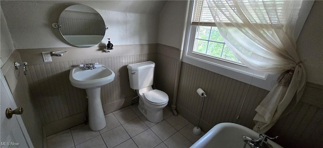 4604 7th Ave, Vienna, WV 26105 - bathroom featuring toilet, a wainscoted wall, tile patterned flooring, and a sink