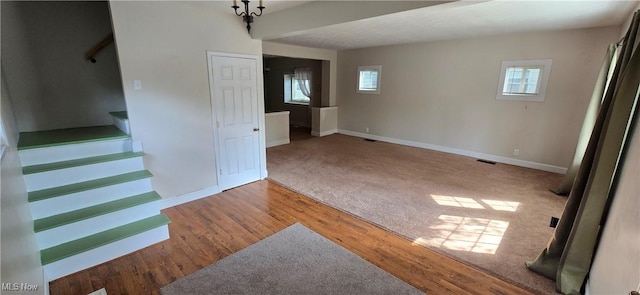 4604 7th Ave, Vienna, WV 26105 - unfurnished living room featuring baseboards, stairway, wood finished floors, and carpet floors