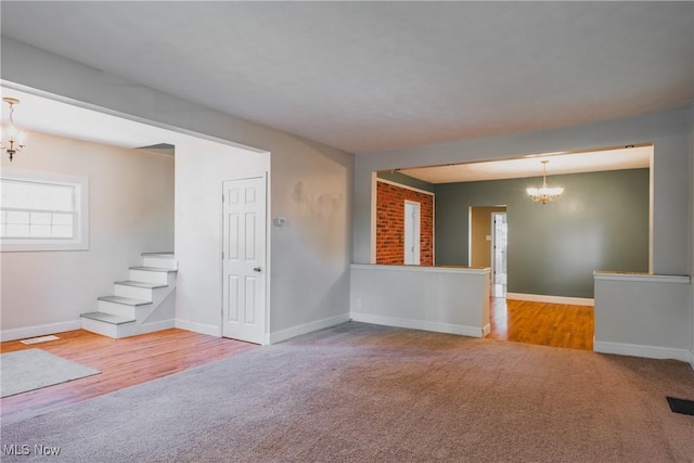 4604 7th Ave, Vienna, WV 26105 - unfurnished living room featuring a chandelier, carpet flooring, and baseboards