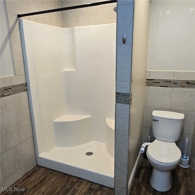4604 7th Ave, Vienna, WV 26105 - bathroom featuring tile walls, a stall shower, wood finished floors, and toilet