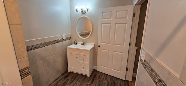 4604 7th Ave, Vienna, WV 26105 - bathroom featuring vanity, wood finished floors, tile walls, and wainscoting