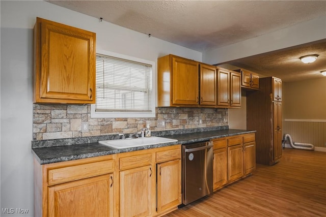 4604 7th Ave, Vienna, WV 26105 - kitchen featuring stainless steel dishwasher, a textured ceiling, dark countertops, backsplash, and light wood-style flooring