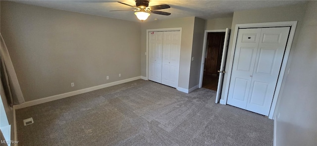 4604 7th Ave, Vienna, WV 26105 - unfurnished bedroom featuring dark colored carpet, multiple closets, baseboards, and ceiling fan