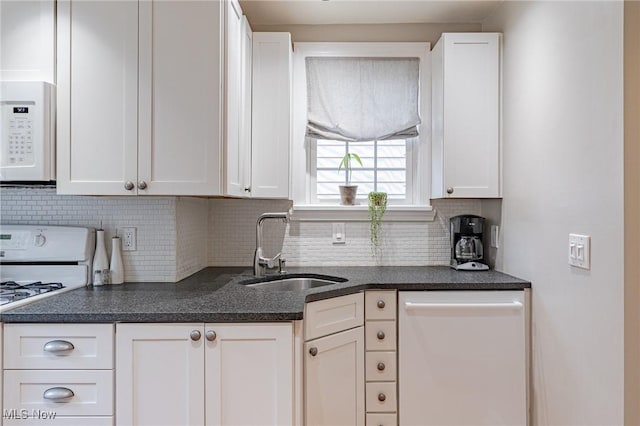 4206 Bushnell Rd, University Heights, OH 44118 - kitchen featuring a sink, white appliances, white cabinets, and decorative backsplash