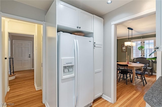 4206 Bushnell Rd, University Heights, OH 44118 - kitchen featuring white refrigerator with ice dispenser, light wood-style flooring, white cabinetry, baseboards, and recessed lighting